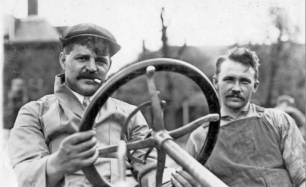 Louis sites in a Buick race car, with his brother, Gaston, next to him