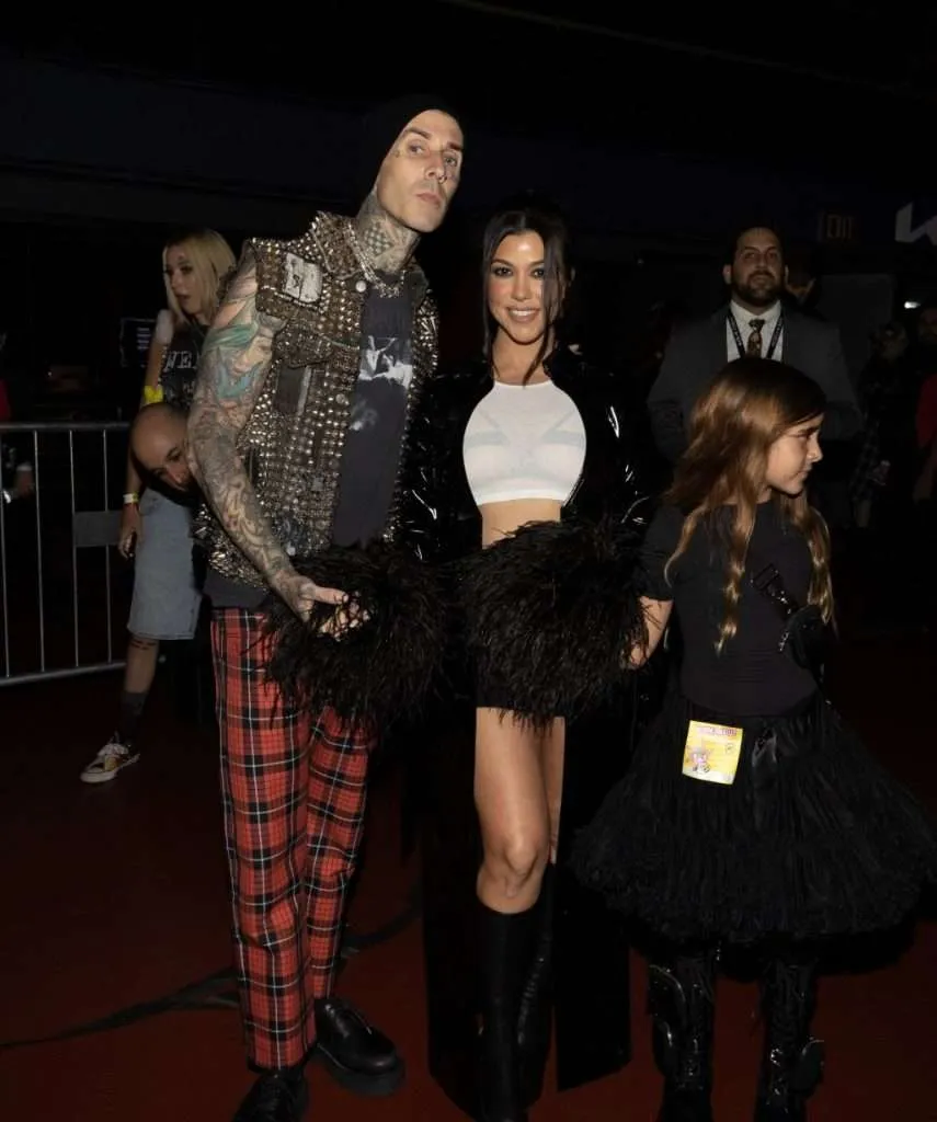 Travis Barker and kourtney kardashian at Kia Forum in Los Angeles.